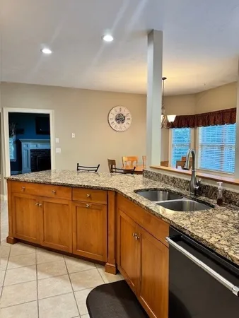 a large kitchen with a sink and cabinets