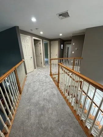 a view of staircase with rug floor