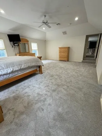 a bedroom with a bed and a ceiling fan