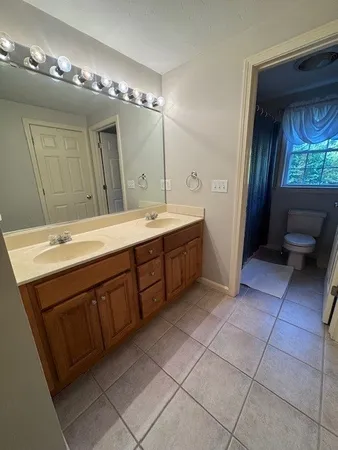 a spacious bathroom with a double vanity sink and a mirror