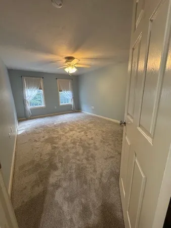 a view of empty room with window and fireplace