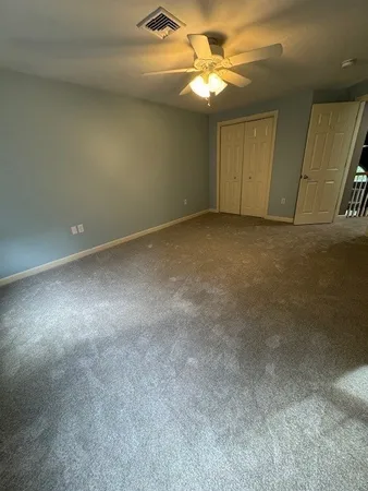 a view of an empty room with a fan