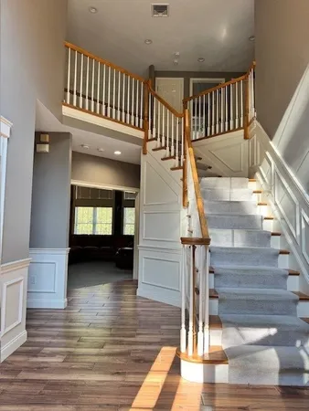 a view of entryway and hall with wooden floor