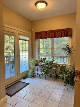 a living room with furniture and large windows