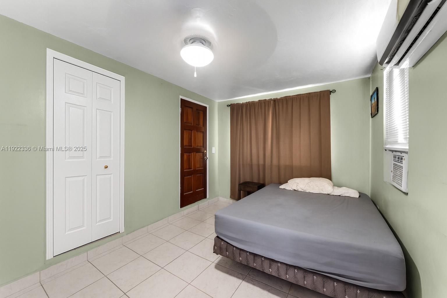 6841 Southwest 1st Street Miami, FL 33144 - Photo 18 of 30 a bedroom with a bed and a window