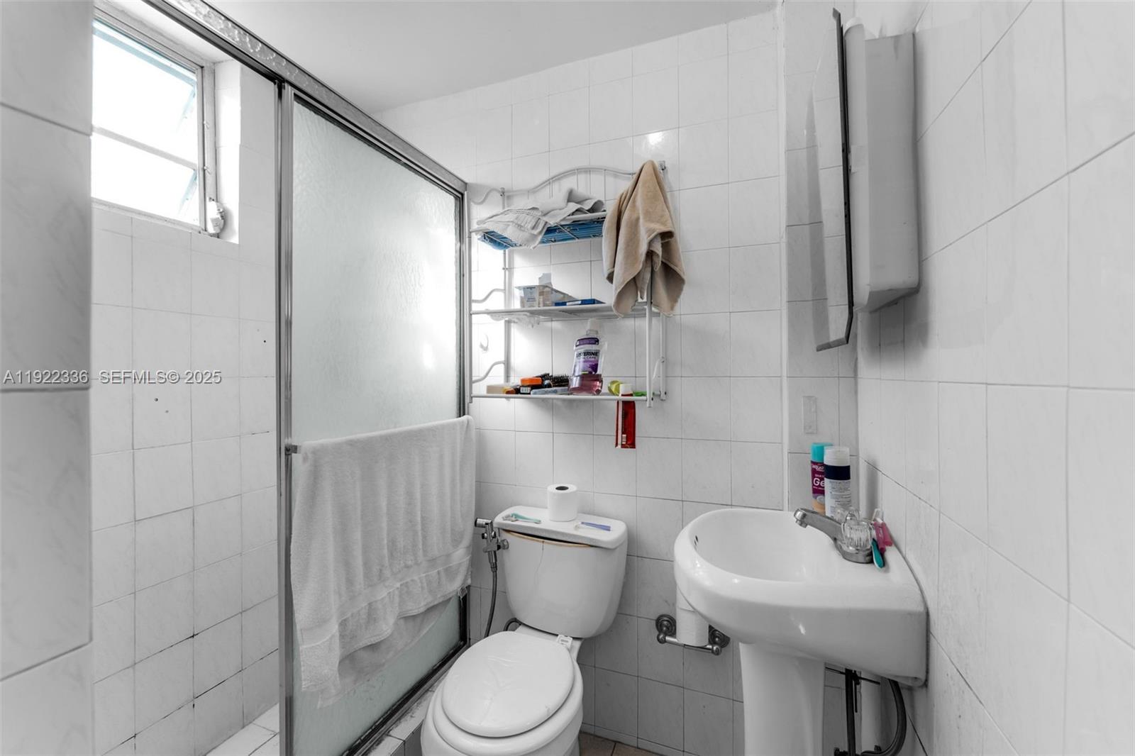 6841 Southwest 1st Street Miami, FL 33144 - Photo 19 of 30 a bathroom with a sink toilet and shower