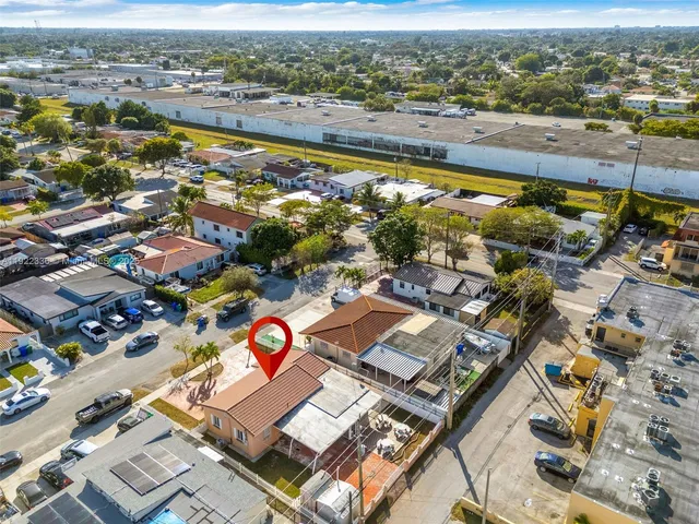 an aerial view of residential houses with outdoor space