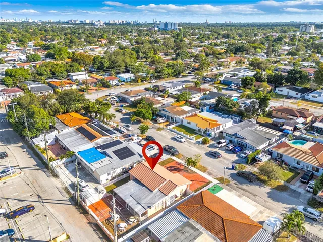 an aerial view of residential houses with outdoor space