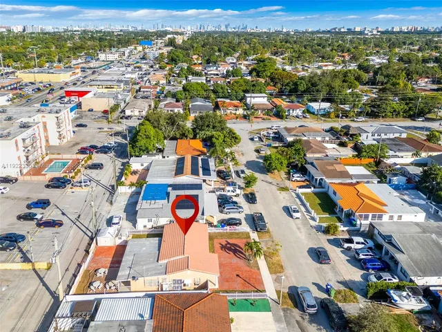 an aerial view of residential houses with outdoor space