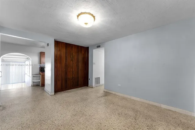 an empty room with windows and closet