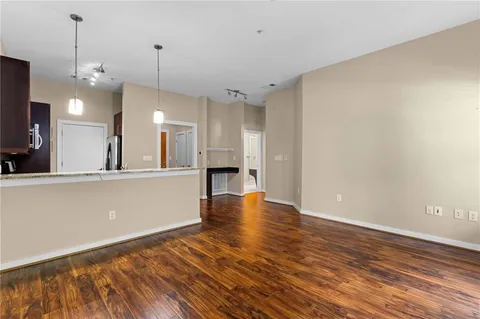 a view of a kitchen with wooden floor and a kitchen