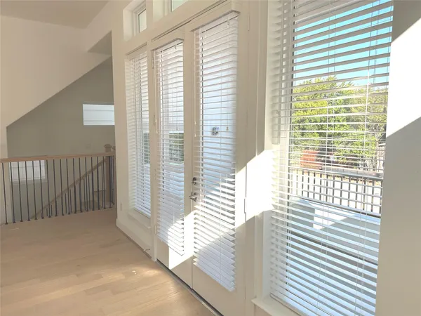 a view of a balcony with a floor to ceiling window