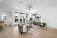 a large kitchen with a large counter top stainless steel appliances and cabinets