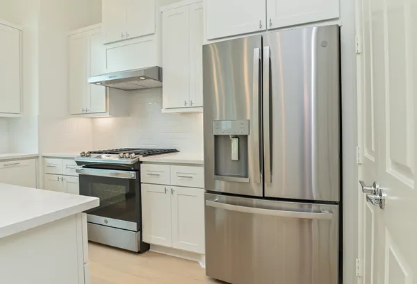 a kitchen with a stove and a refrigerator