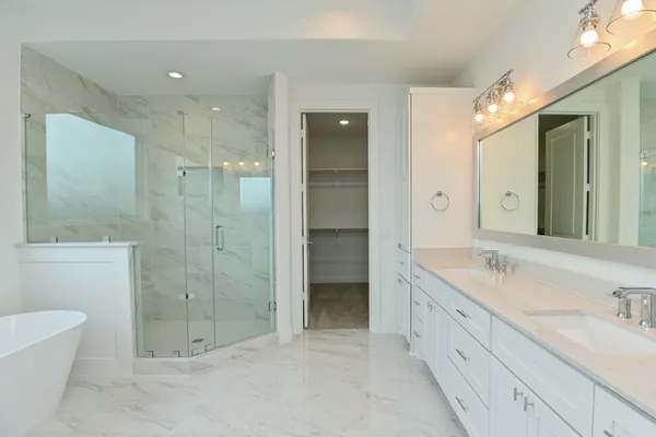 a spacious bathroom with a granite countertop sink mirror and shower