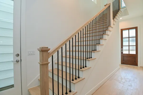 a view of entryway with wooden floor and stairs