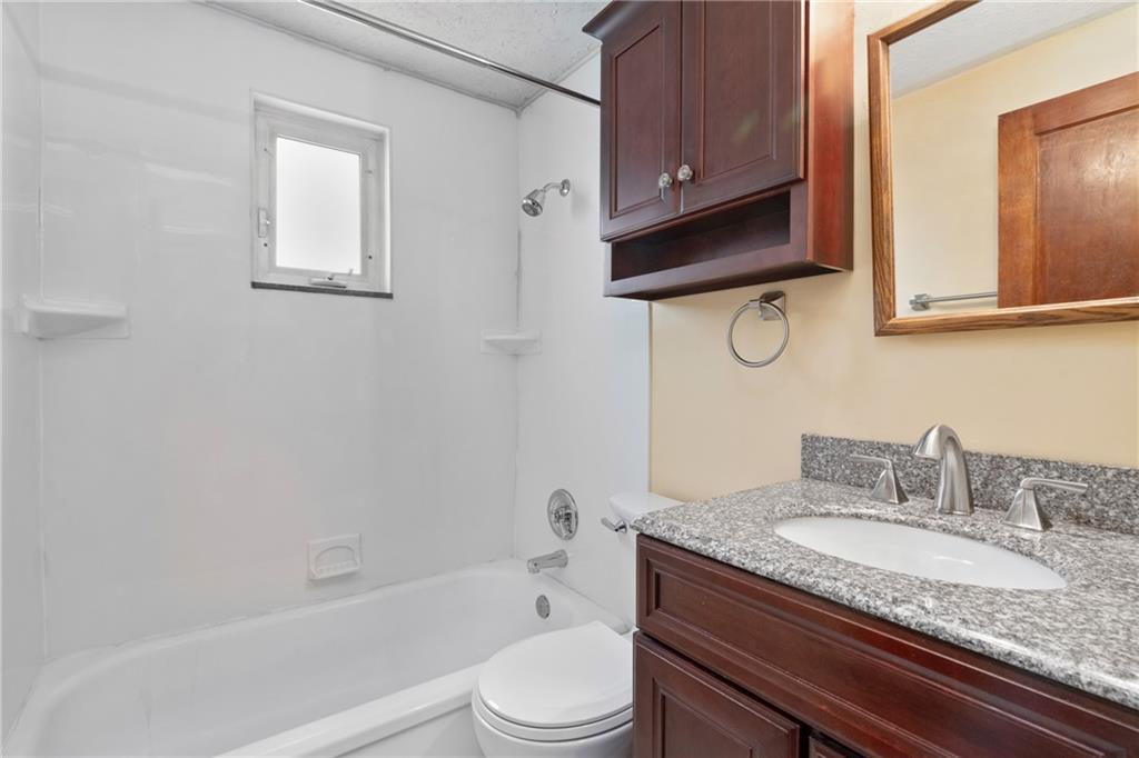 459 East Garden Road Pittsburgh, PA 15227 - Photo 15 of 33 a bathroom with a granite countertop toilet sink and mirror
