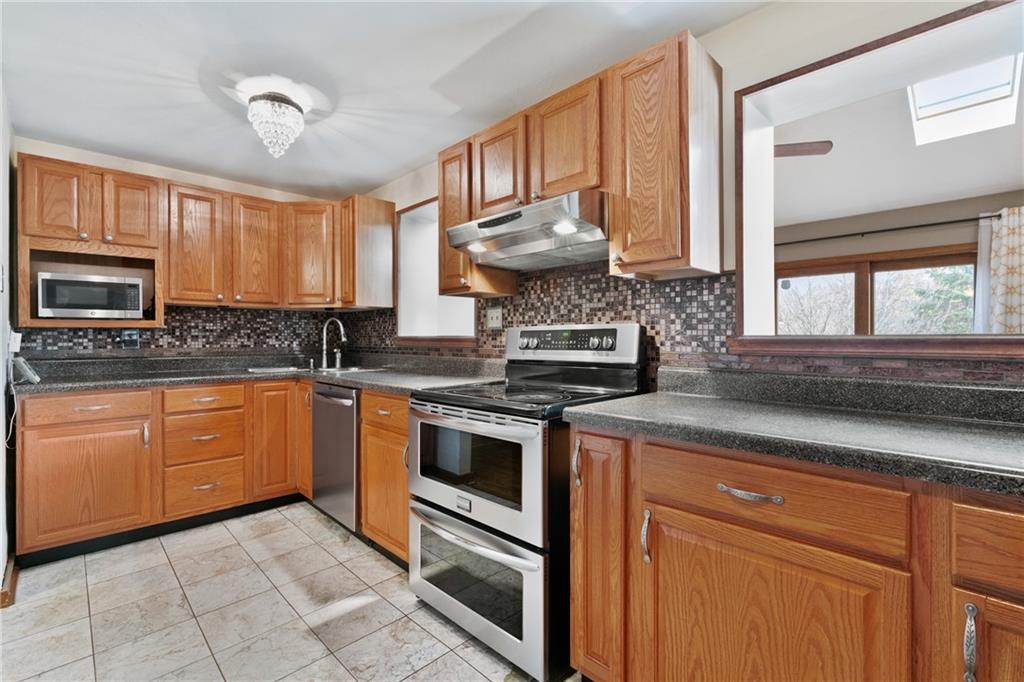 459 East Garden Road Pittsburgh, PA 15227 - Photo 5 of 33 a kitchen with stainless steel appliances granite countertop a stove sink and cabinets