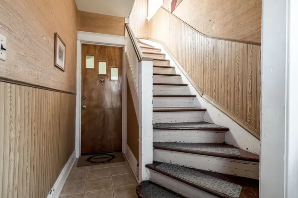 a view of entryway with wooden floor and stairs