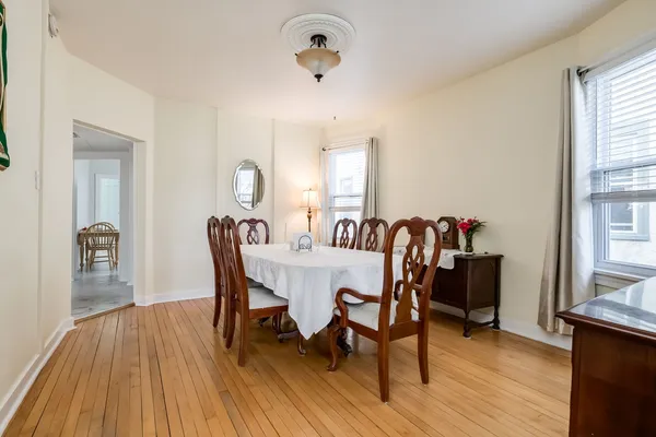 a view of a dining room with furniture and wooden floor