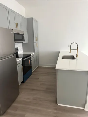 a kitchen with a sink and stainless steel appliances
