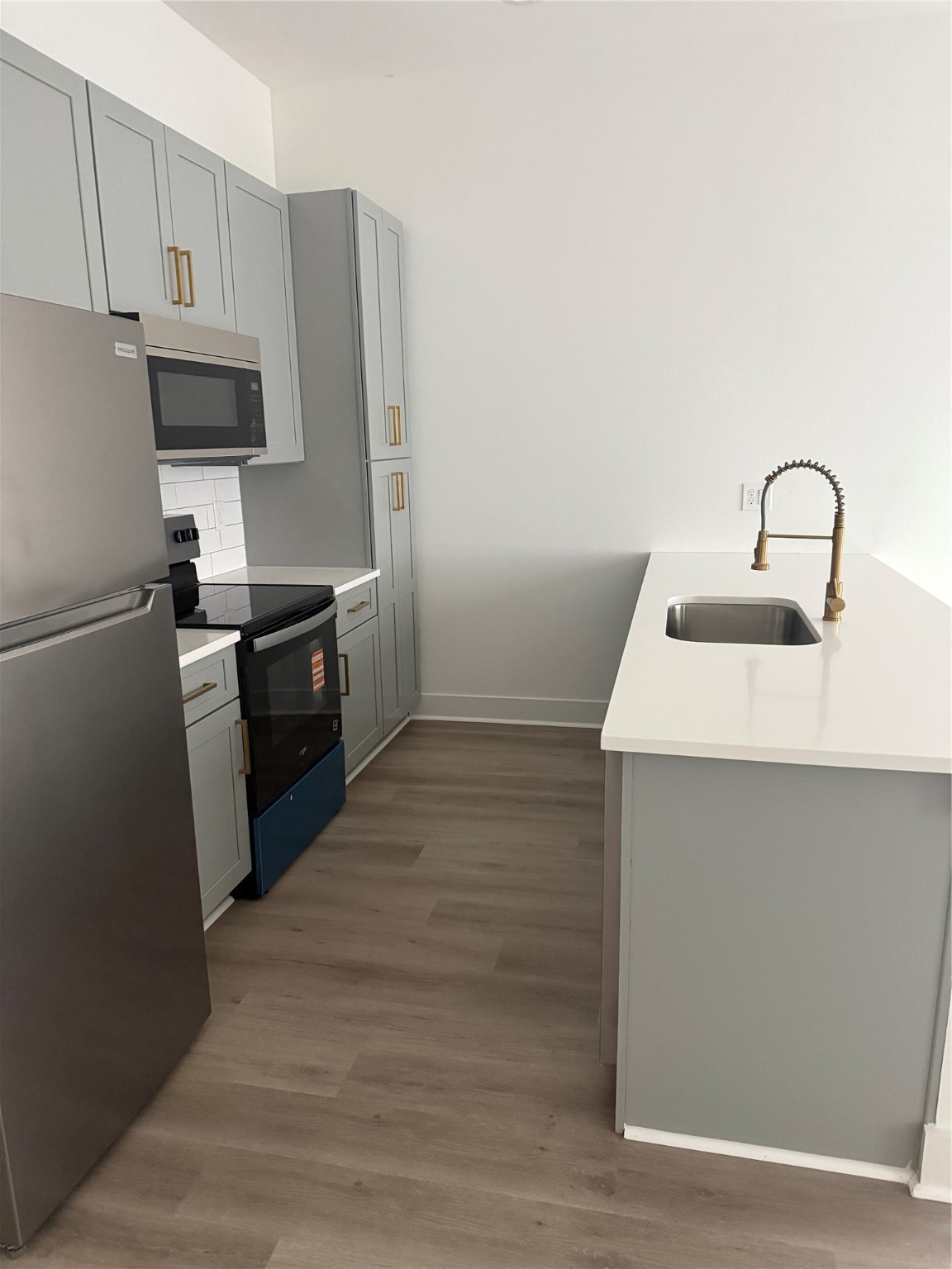 a kitchen with a sink and stainless steel appliances