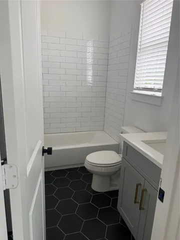 a bathroom with a toilet a sink and shower