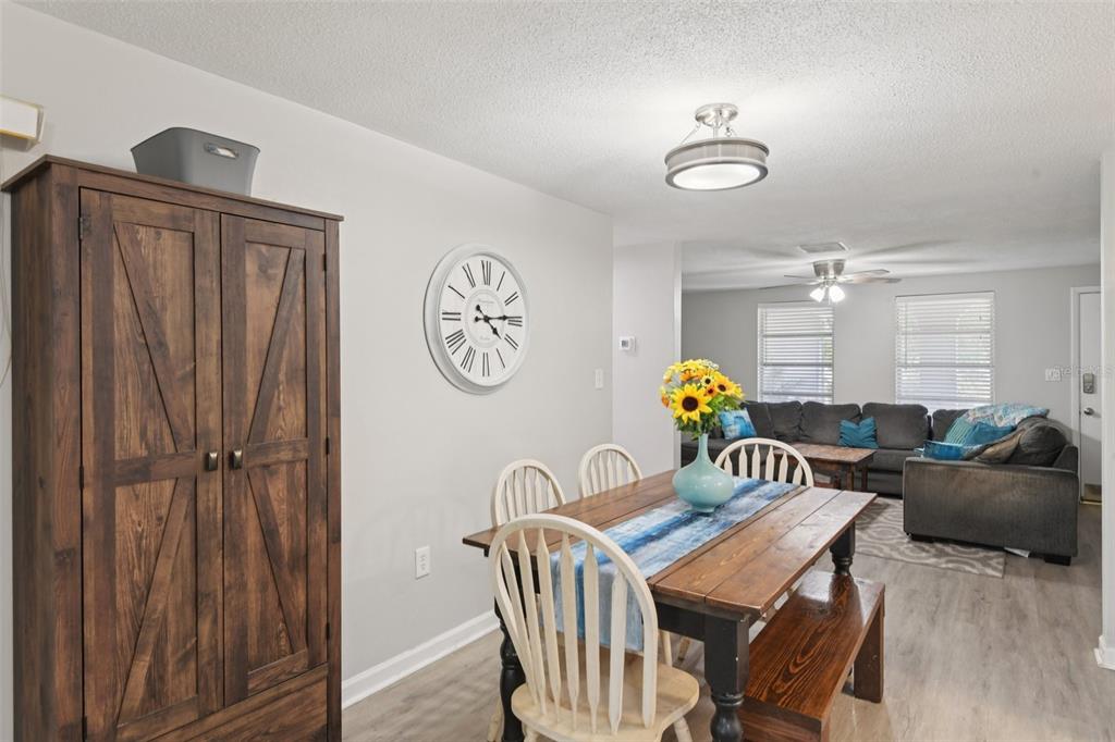 7102 Cherry Laurel Drive Port Richey, FL 34668 - Photo 14 of 39 a view of a dining room with furniture chandelier and wooden floor