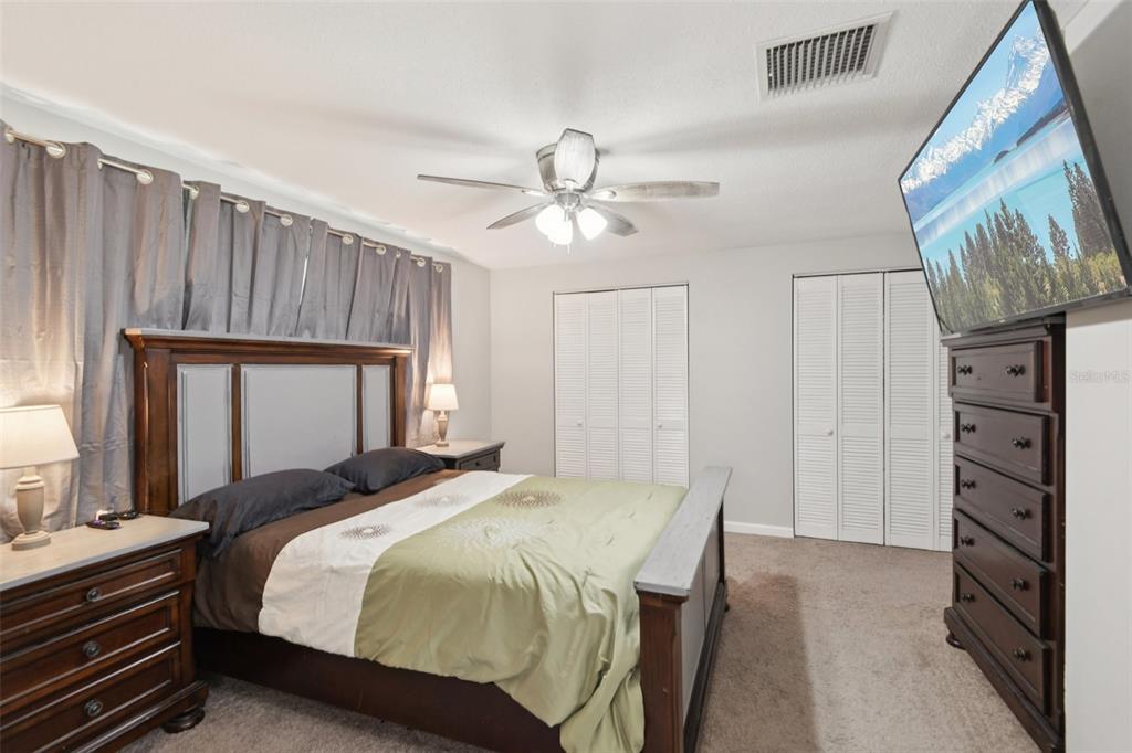 7102 Cherry Laurel Drive Port Richey, FL 34668 - Photo 16 of 39 a bedroom with a bed and a chandelier