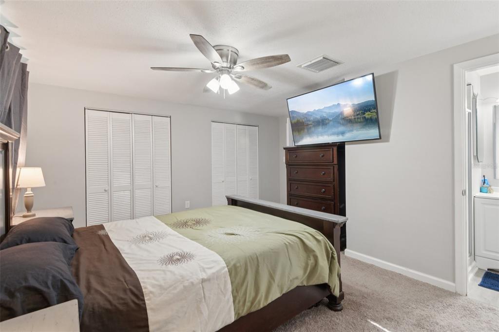 7102 Cherry Laurel Drive Port Richey, FL 34668 - Photo 17 of 39 a bedroom with a bed and a painting on the wall