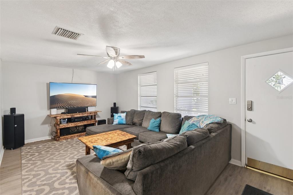 7102 Cherry Laurel Drive Port Richey, FL 34668 - Photo 2 of 39 a living room with furniture and a flat screen tv