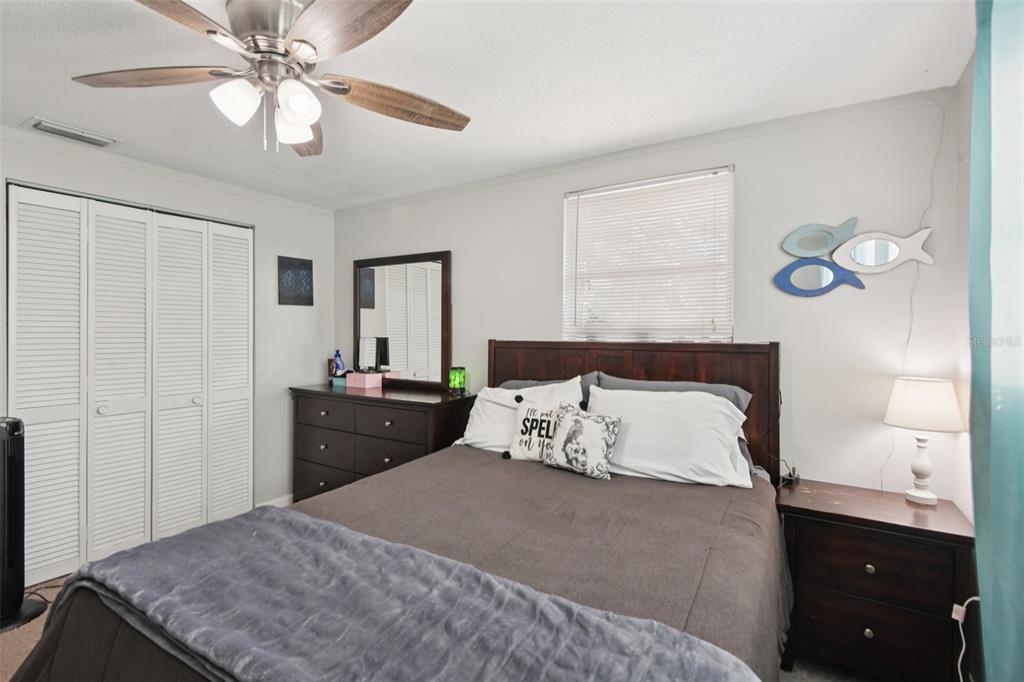 7102 Cherry Laurel Drive Port Richey, FL 34668 - Photo 21 of 39 a bedroom with a bed and a chandelier