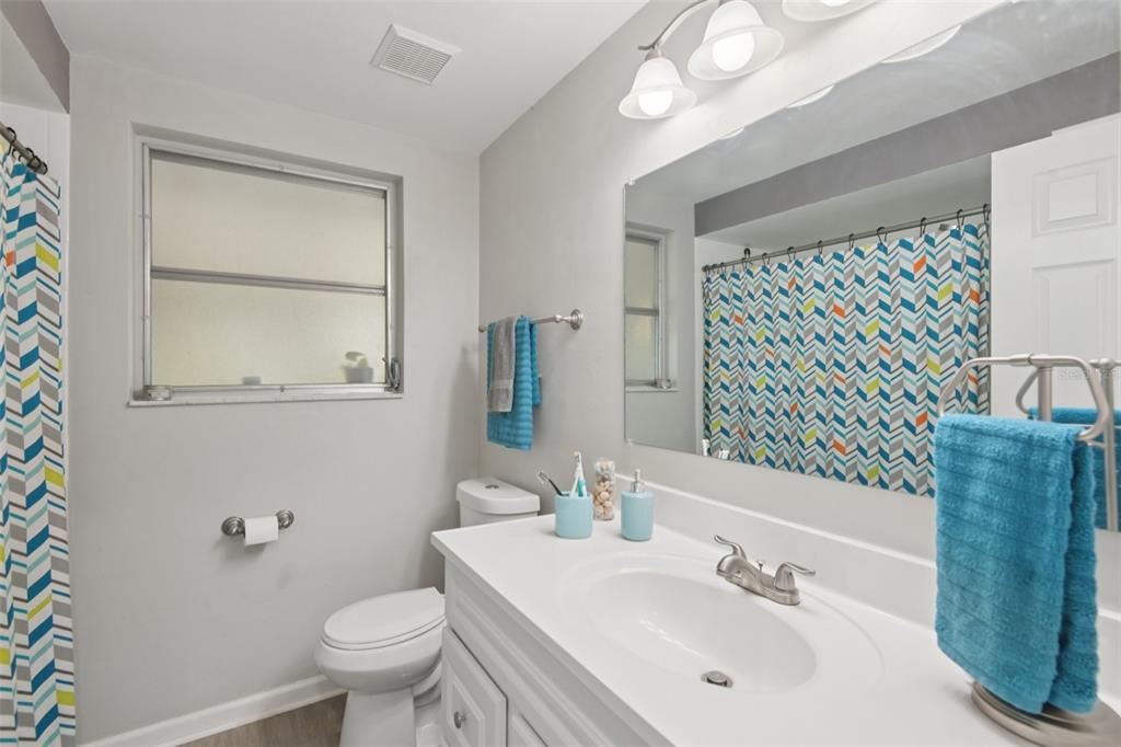 7102 Cherry Laurel Drive Port Richey, FL 34668 - Photo 22 of 39 a bathroom with a sink a toilet and mirror