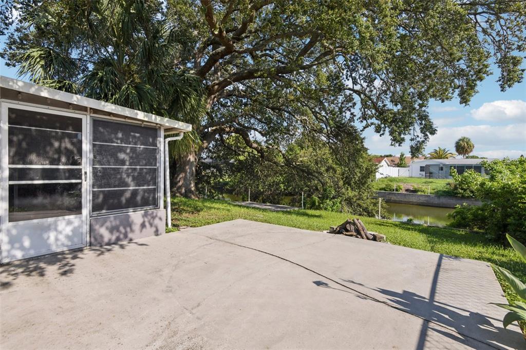 7102 Cherry Laurel Drive Port Richey, FL 34668 - Photo 29 of 39 a view of backyard with wooden fence and large trees