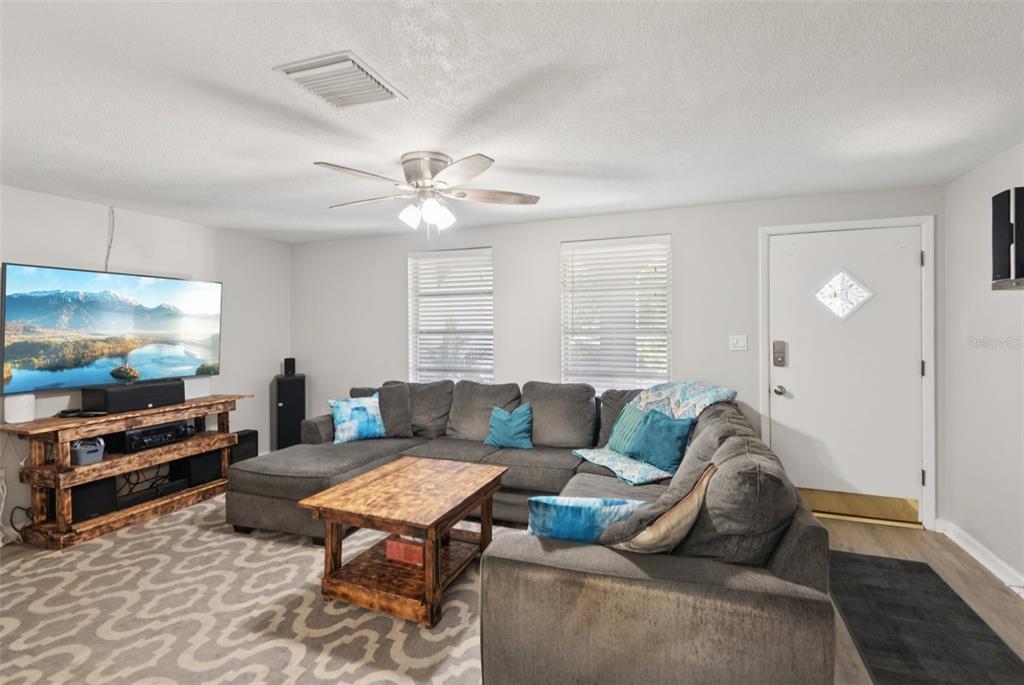 7102 Cherry Laurel Drive Port Richey, FL 34668 - Photo 3 of 39 a living room with furniture and a flat screen tv