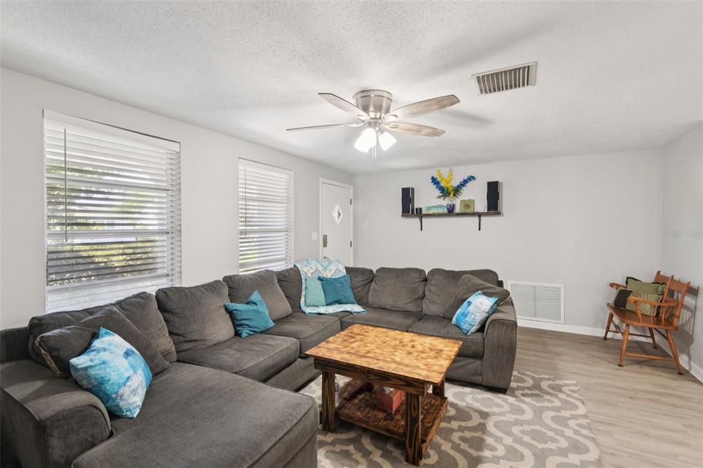 7102 Cherry Laurel Drive Port Richey, FL 34668 - Photo 4 of 39 a living room with furniture ceiling fan and a window