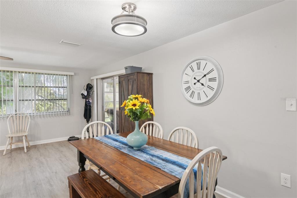 7102 Cherry Laurel Drive Port Richey, FL 34668 - Photo 6 of 39 a view of a dining room with furniture and a large window