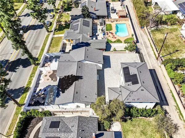an aerial view of multiple houses with yard