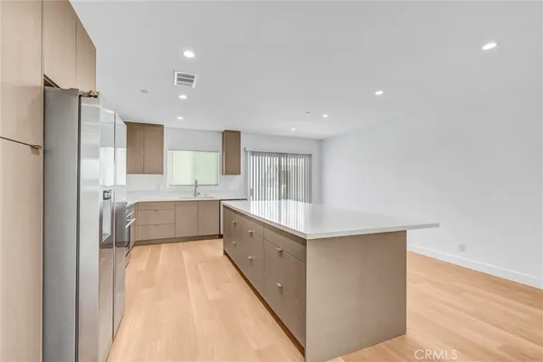 a large room with a large window and stainless steel appliances
