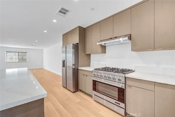 a kitchen with a stove and a refrigerator