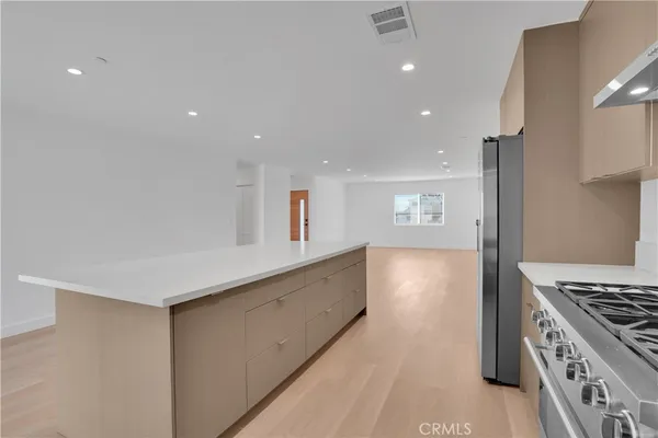 a kitchen with granite countertop a stove and a refrigerator