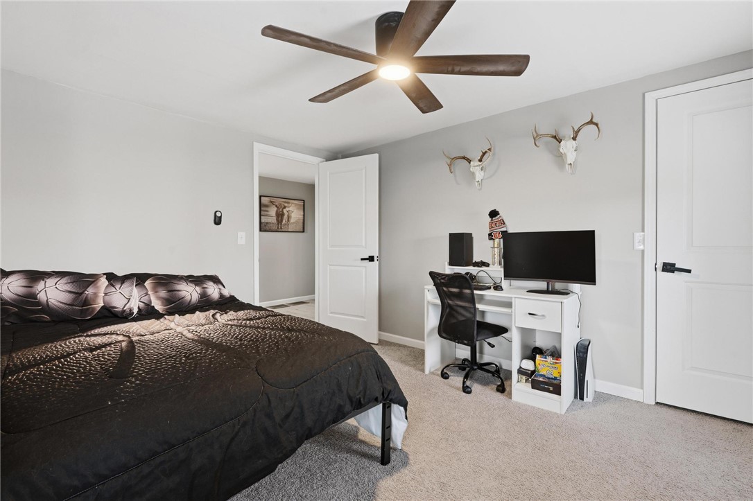 2950 Fairfield Pike Springfield, OH 45502 - Photo 23 of 48 This spacious bedroom offers a bright and inviting atmosphere with carpeted flooring and a ceiling fan.