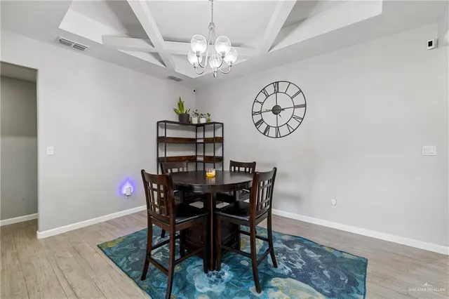 a view of a dining room with furniture and chandelier