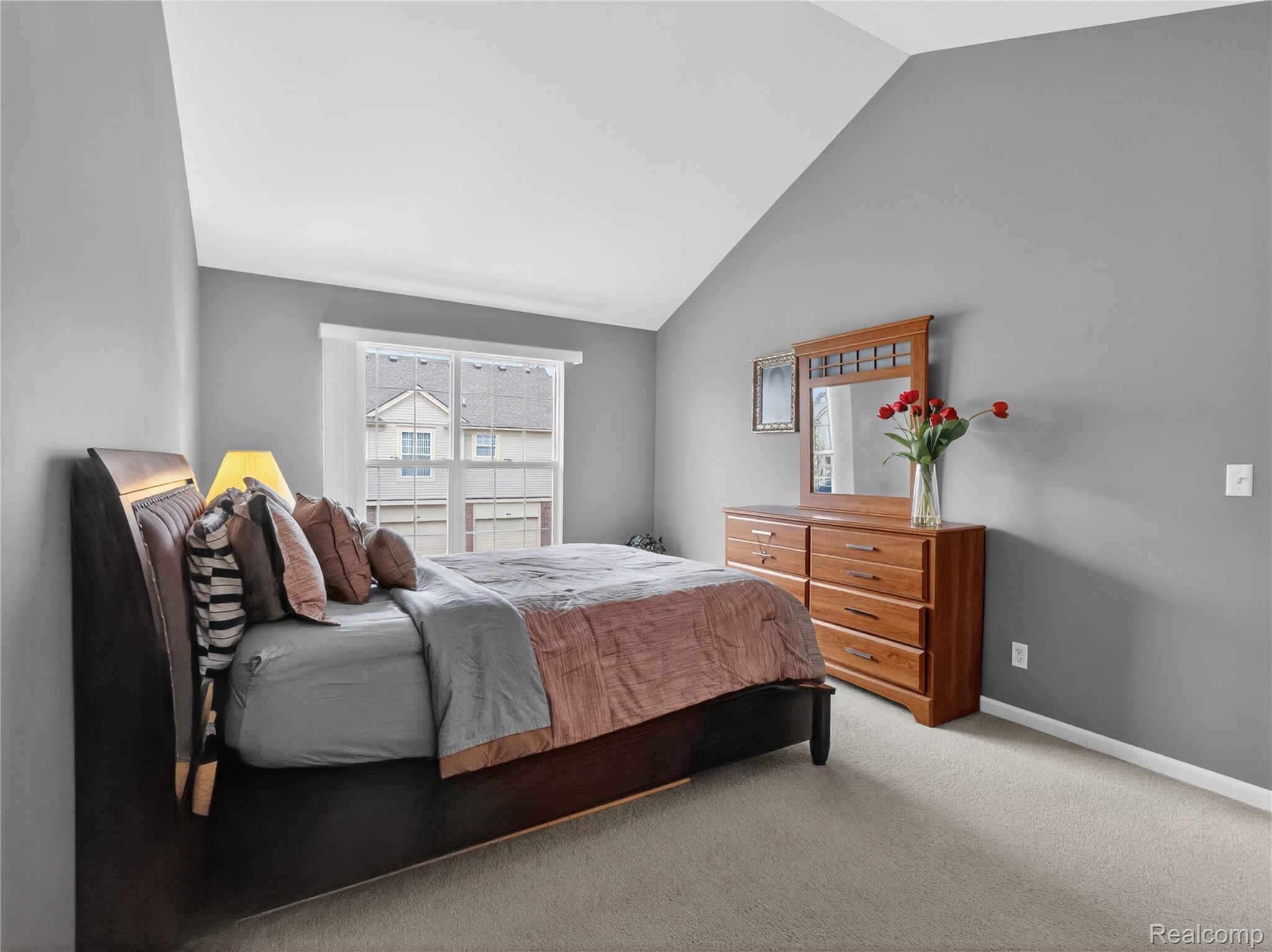 1834 Flagstone Circle, Unit 37 Rochester, MI 48307 - Photo 19 of 31 Bedroom featuring vaulted ceiling and light carpet