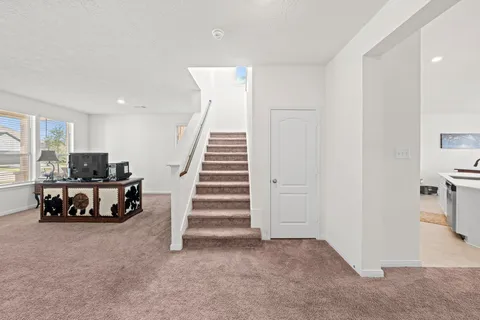 a view of a livingroom with furniture and stairs