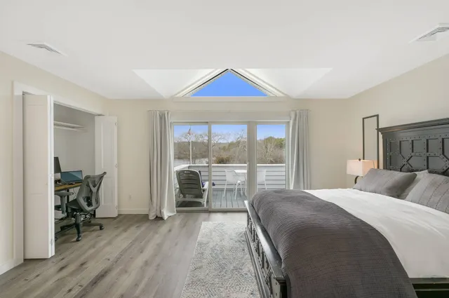 a bedroom with a bed and a large window