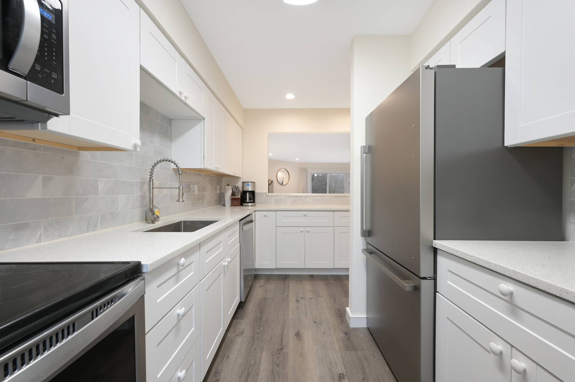 Undisclosed Address Westhampton, NY 11977 - Photo 9 of 18 a kitchen with white cabinets and appliances