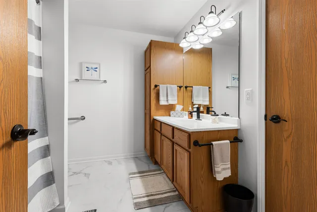 a bathroom with a sink double vanity and a mirror