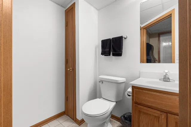 a bathroom with a toilet a sink and a mirror