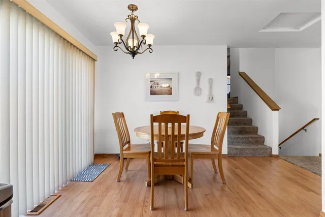 a view of a dining room with furniture wooden floor and chandelier